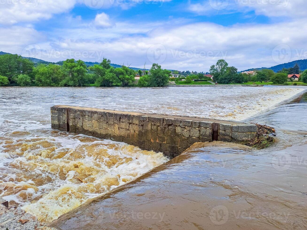 The river Berunka swollen after heavy rainfall and flood water crashing valley photo