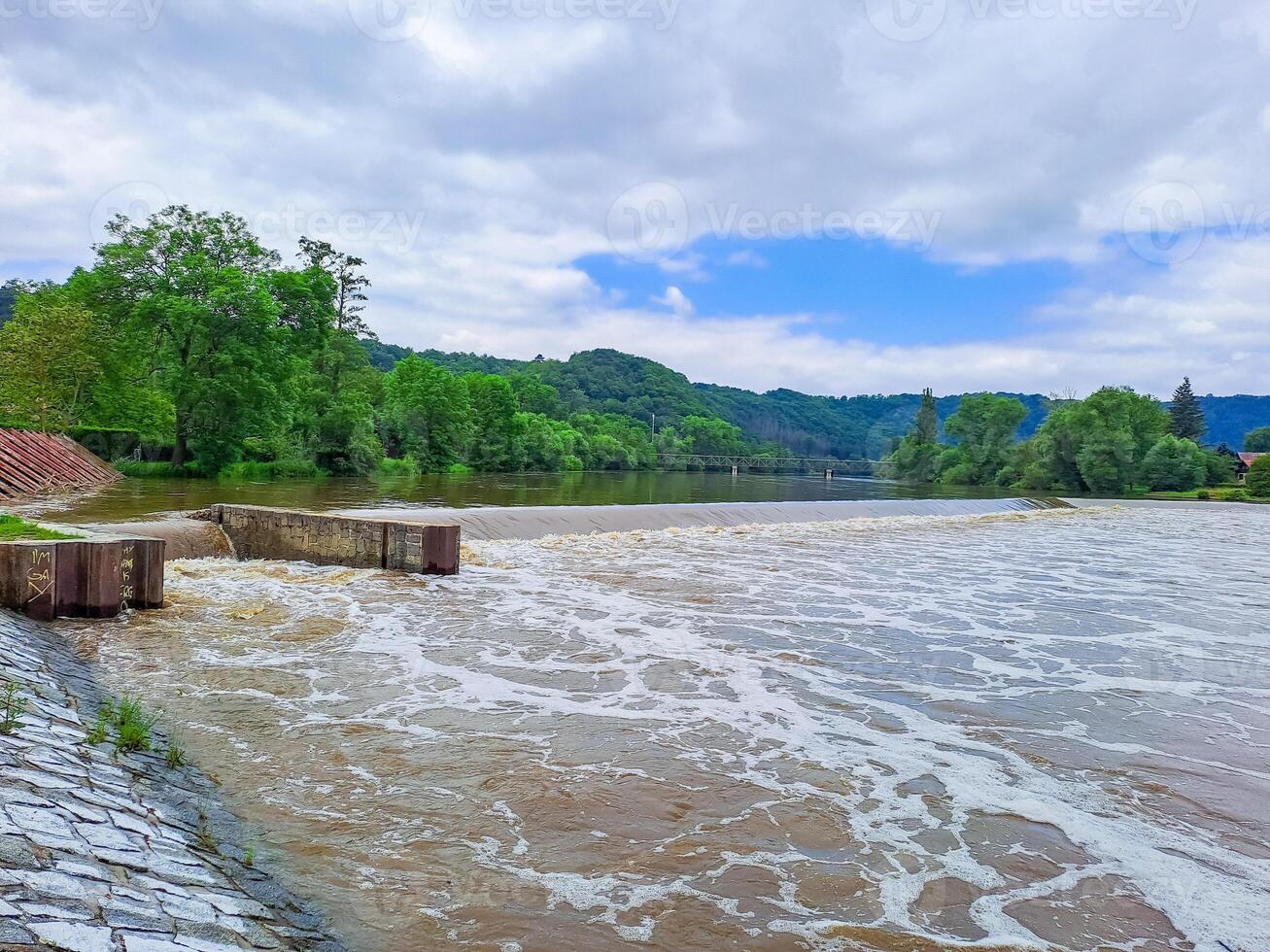 The river Berunka swollen after heavy rainfall and flood water crashing valley photo