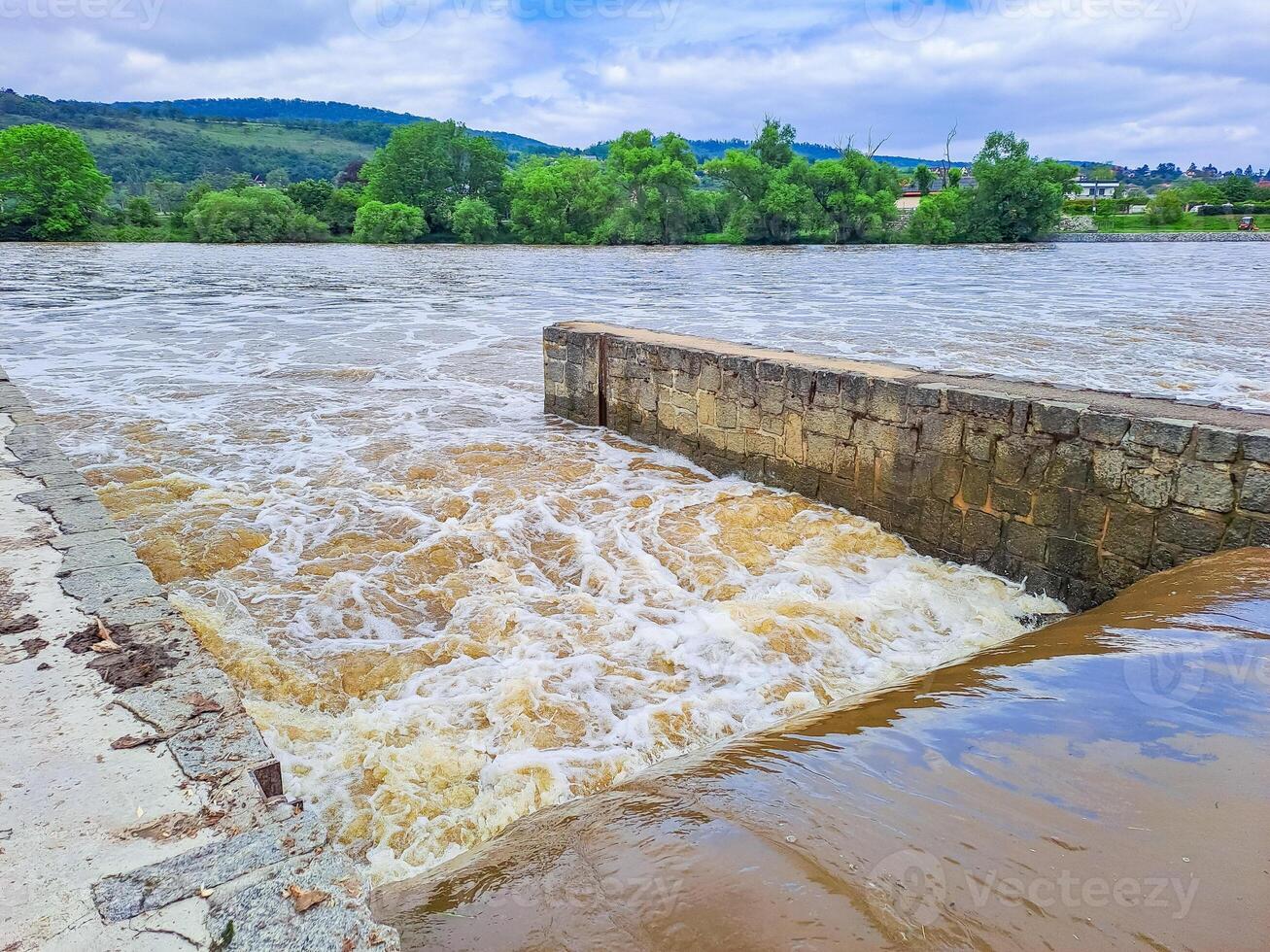 The river Berunka swollen after heavy rainfall and flood water crashing valley photo