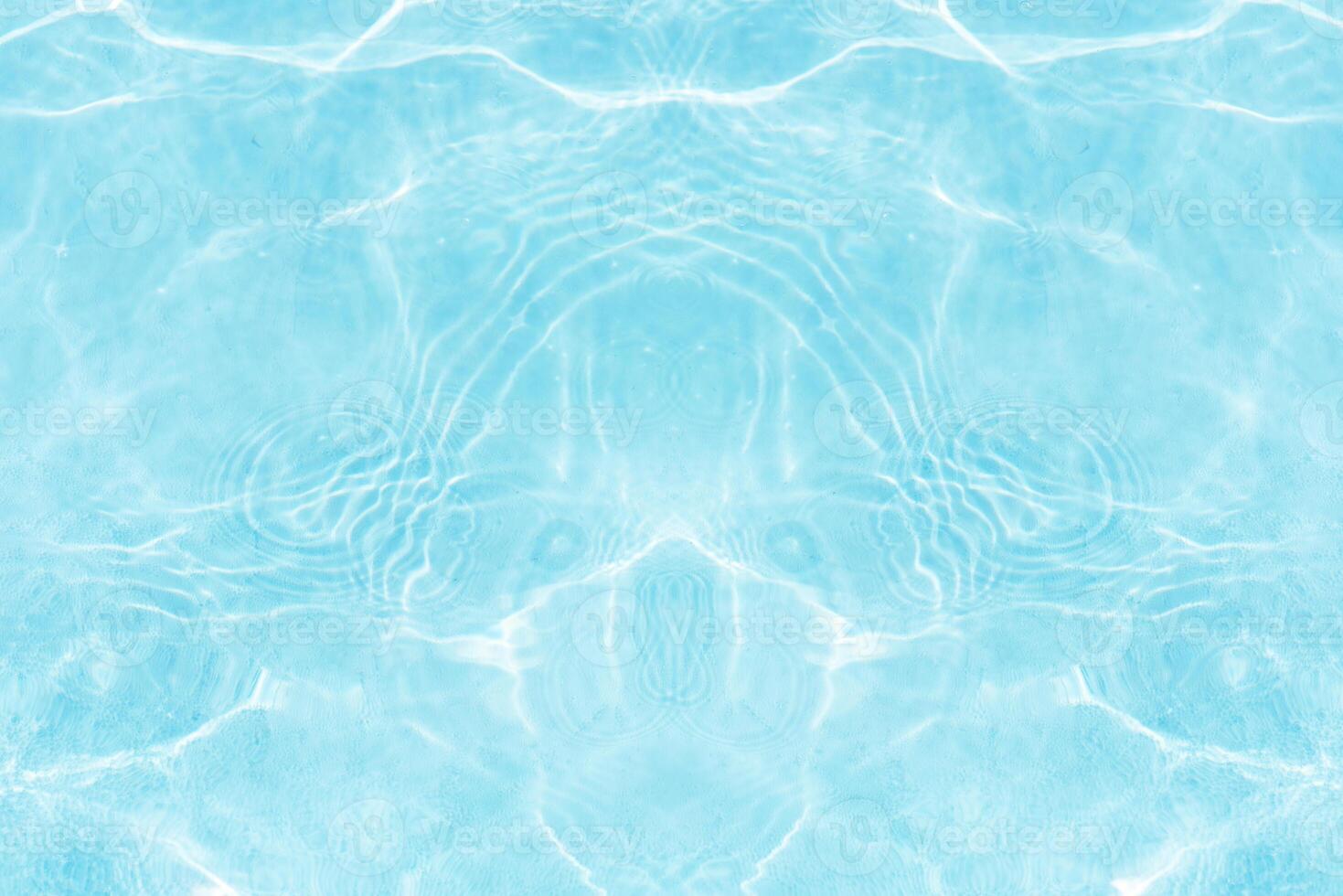 Blue water with ripples on the surface. Defocus blurred transparent blue colored clear calm water surface texture with splashes and bubbles. Water waves with shining pattern texture background. photo