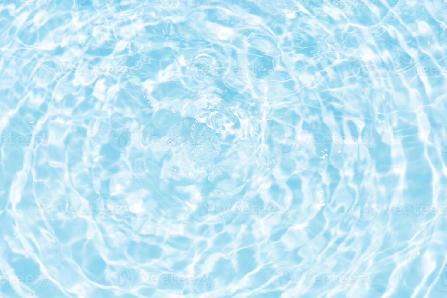 Blue water with ripples on the surface. Defocus blurred transparent blue colored clear calm water surface texture with splashes and bubbles. Water waves with shining pattern texture background. photo