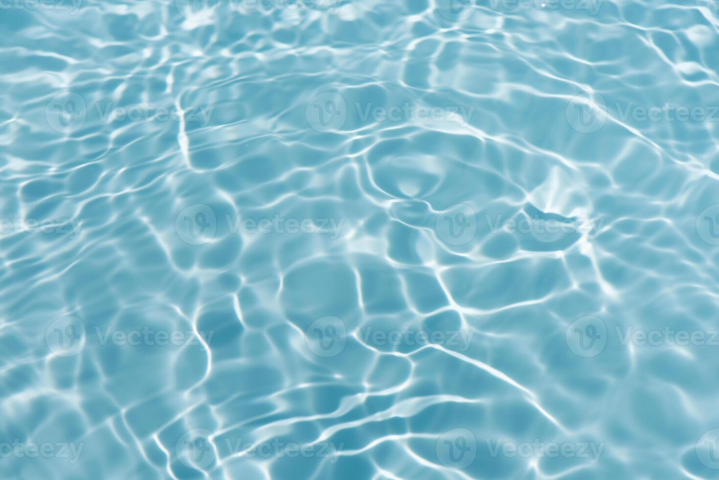 Blue water with ripples on the surface. Defocus blurred transparent blue colored clear calm water surface texture with splashes and bubbles. Water waves with shining pattern texture background. photo