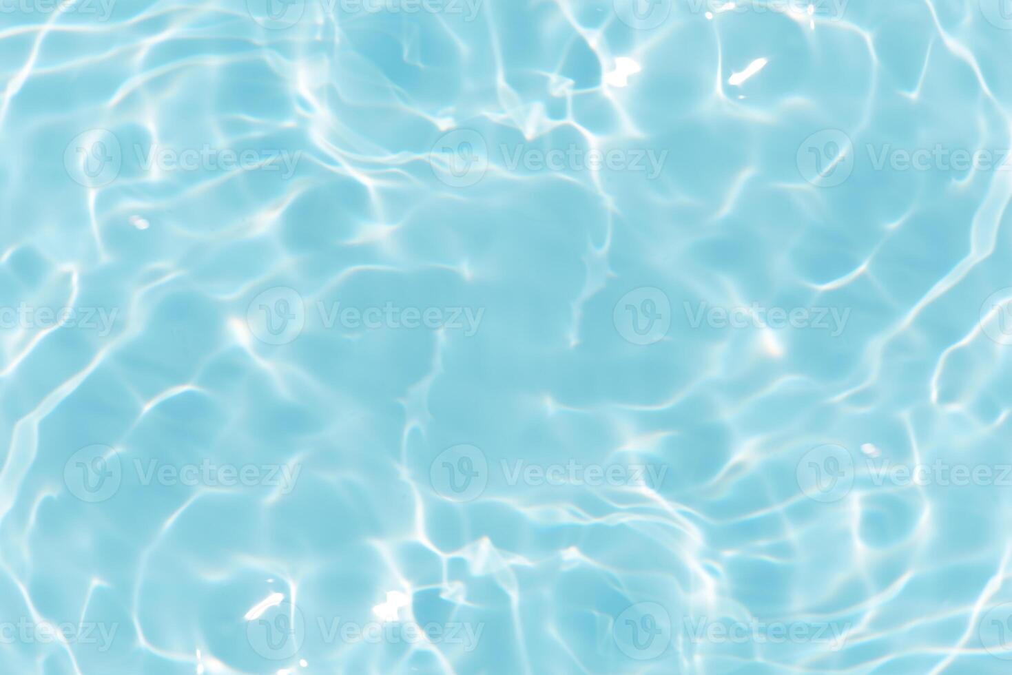 Bluewater waves on the surface ripples blurred. Defocus blurred transparent blue colored clear calm water surface texture with splash and bubbles. Water waves with shining pattern texture background. photo