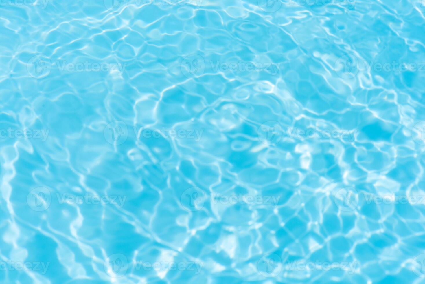 Blue water with ripples on the surface. Defocus blurred transparent blue colored clear calm water surface texture with splashes and bubbles. Water waves with shining pattern texture background. photo