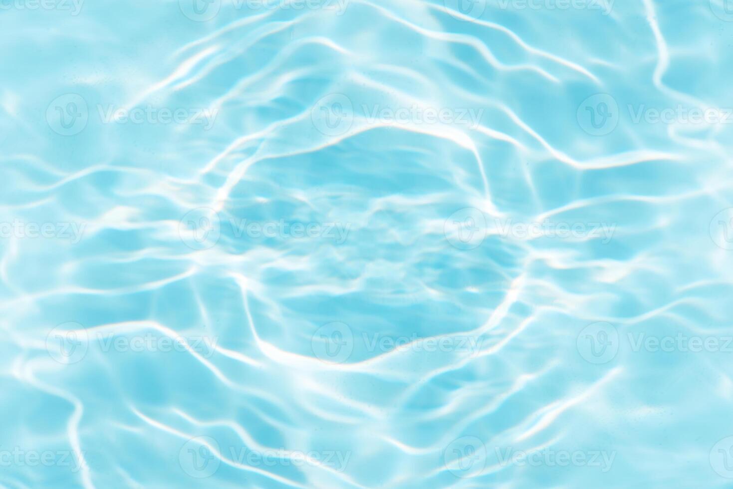 Bluewater waves on the surface ripples blurred. Defocus blurred transparent blue colored clear calm water surface texture with splash and bubbles. Water waves with shining pattern texture background. photo