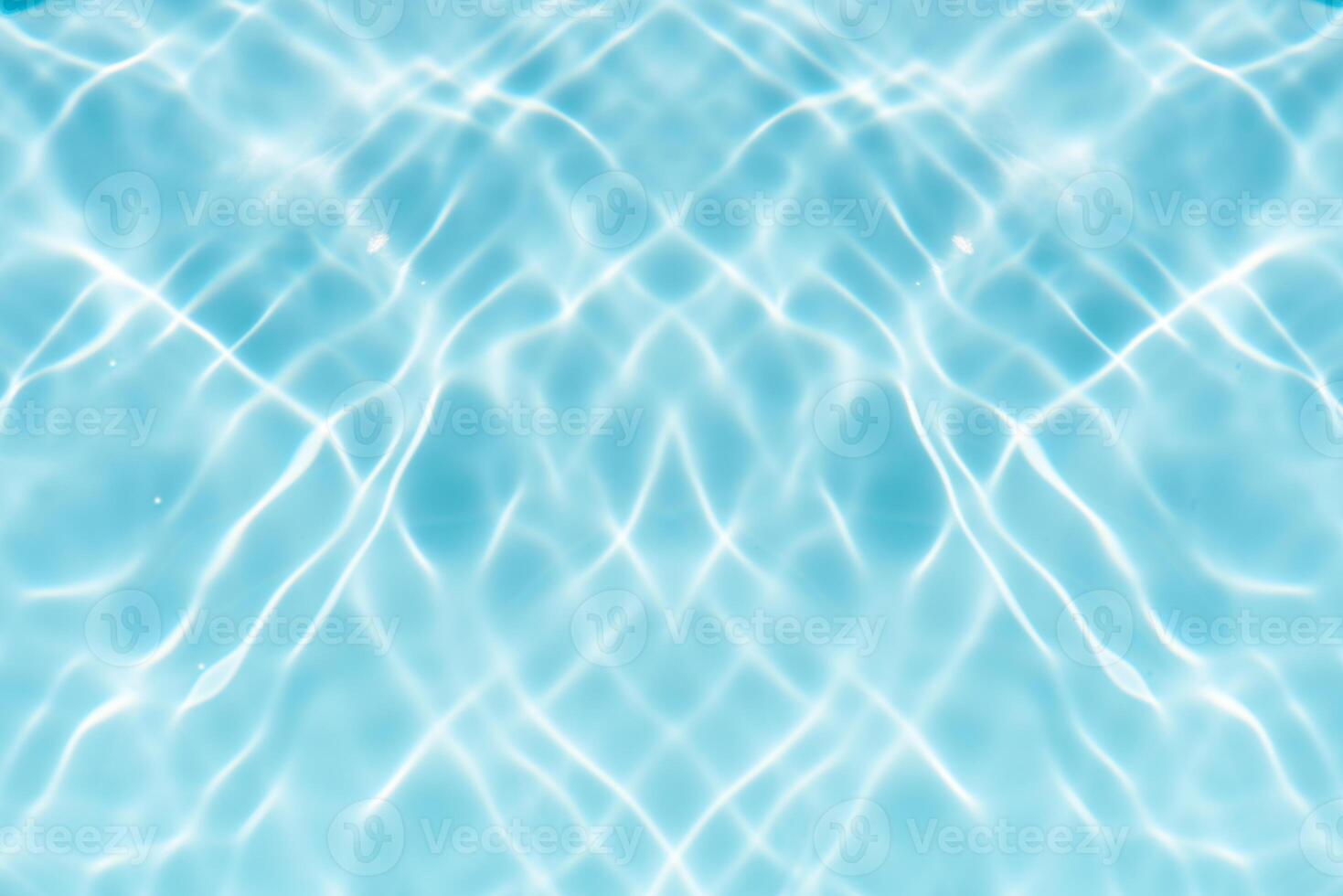 Blue water with ripples on the surface. Defocus blurred transparent blue colored clear calm water surface texture with splashes and bubbles. Water waves with shining pattern texture background. photo