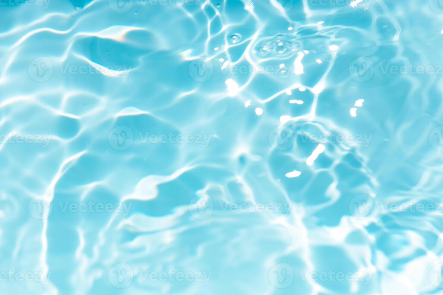 Bluewater waves on the surface ripples blurred. Defocus blurred transparent blue colored clear calm water surface texture with splash and bubbles. Water waves with shining pattern texture background. photo