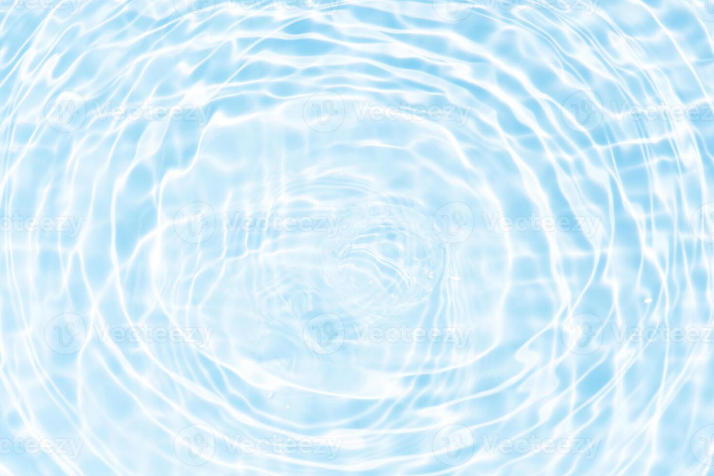 Bluewater waves on the surface ripples blurred. Defocus blurred transparent blue colored clear calm water surface texture with splash and bubbles. Water waves with shining pattern texture background. photo