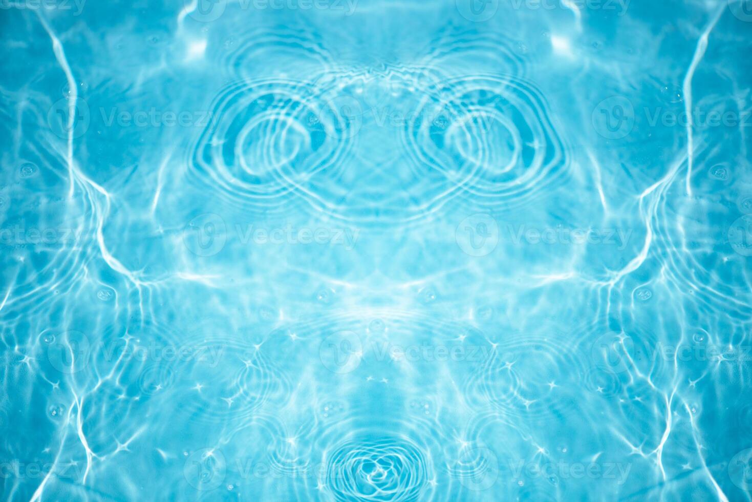 Blue water with ripples on the surface. Defocus blurred transparent blue colored clear calm water surface texture with splashes and bubbles. Water waves with shining pattern texture background. photo
