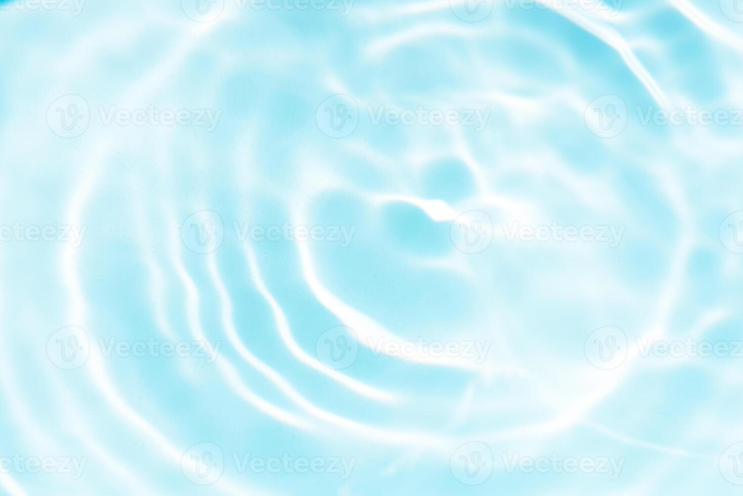 Bluewater waves on the surface ripples blurred. Defocus blurred transparent blue colored clear calm water surface texture with splash and bubbles. Water waves with shining pattern texture background. photo