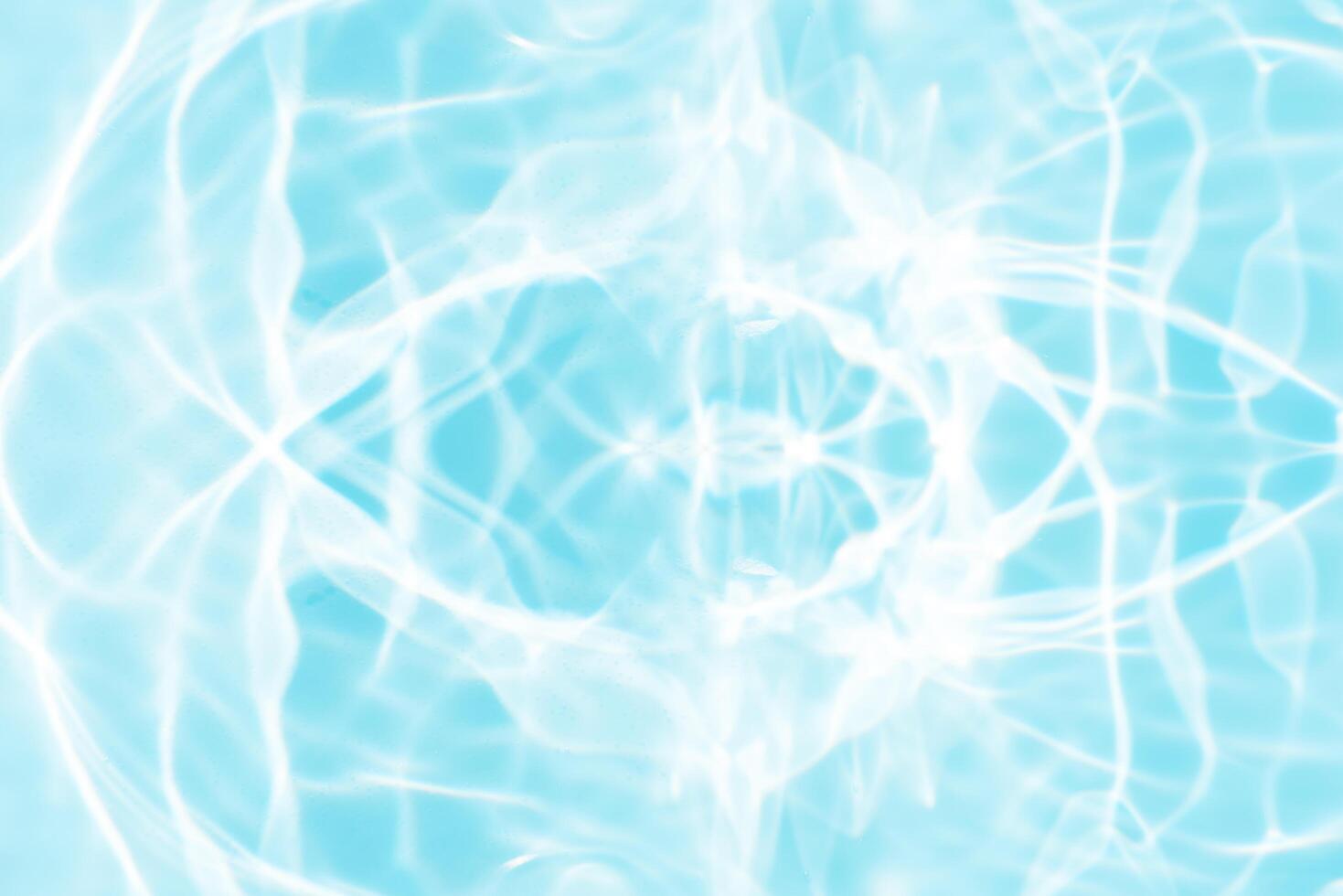 Bluewater waves on the surface ripples blurred. Defocus blurred transparent blue colored clear calm water surface texture with splash and bubbles. Water waves with shining pattern texture background. photo