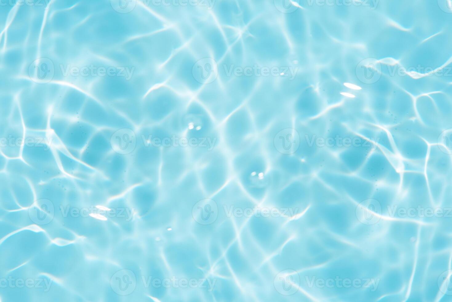 Bluewater waves on the surface ripples blurred. Defocus blurred transparent blue colored clear calm water surface texture with splash and bubbles. Water waves with shining pattern texture background. photo