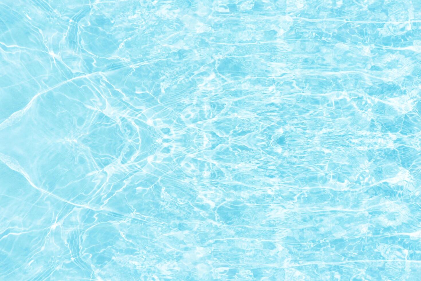 Bluewater waves on the surface ripples blurred. Defocus blurred transparent blue colored clear calm water surface texture with splash and bubbles. Water waves with shining pattern texture background. photo