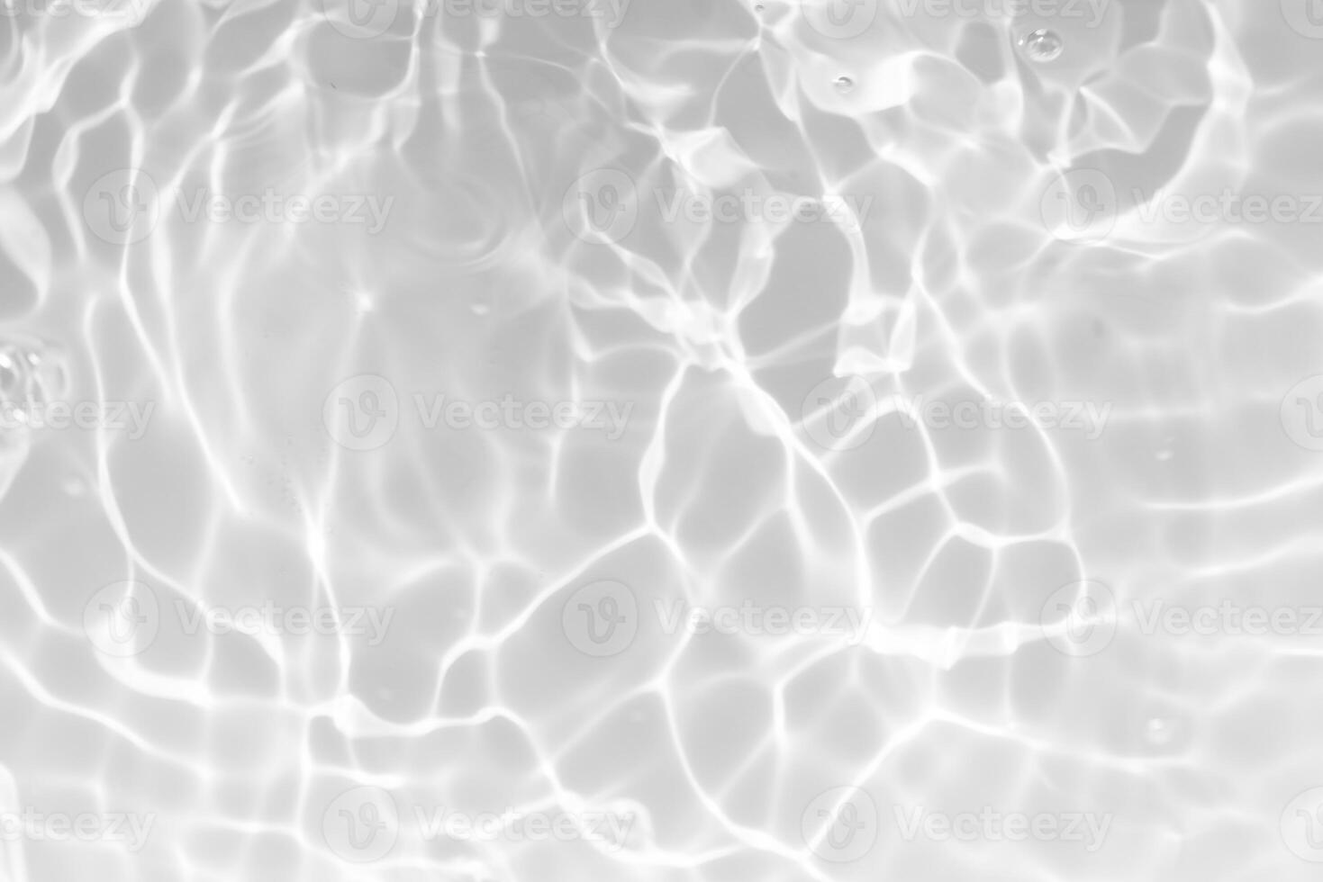 Blue water with ripples on the surface. Defocus blurred transparent blue colored clear calm water surface texture with splashes and bubbles. Water waves with shining pattern texture background. photo