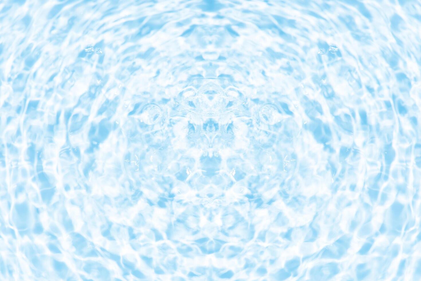 Blue water with ripples on the surface. Defocus blurred transparent blue colored clear calm water surface texture with splashes and bubbles. Water waves with shining pattern texture background. photo