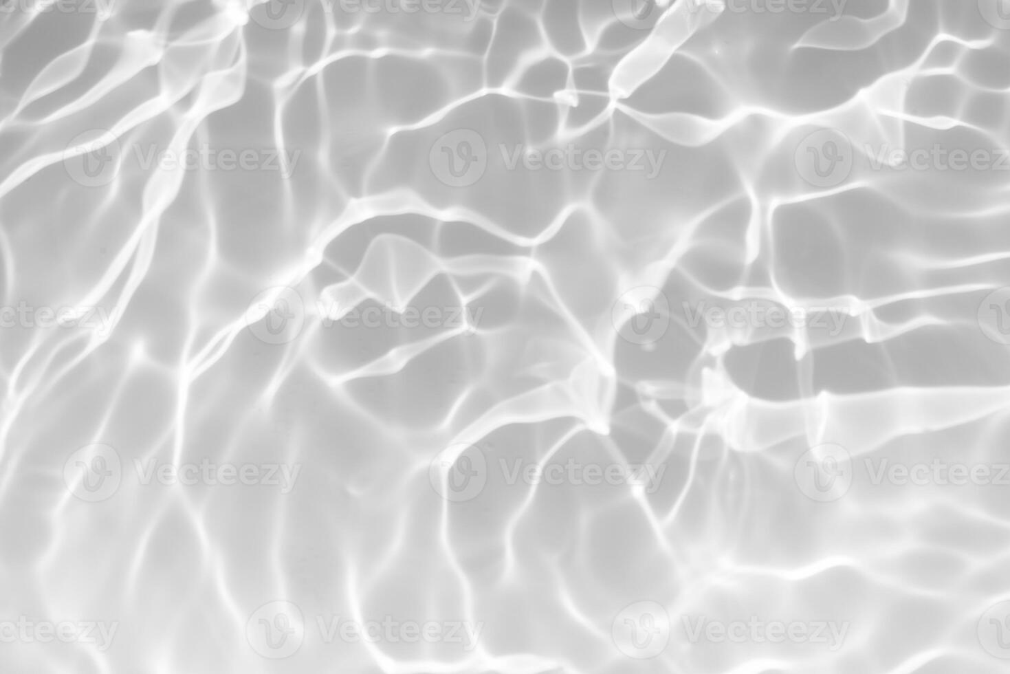 Blue water with ripples on the surface. Defocus blurred transparent blue colored clear calm water surface texture with splashes and bubbles. Water waves with shining pattern texture background. photo