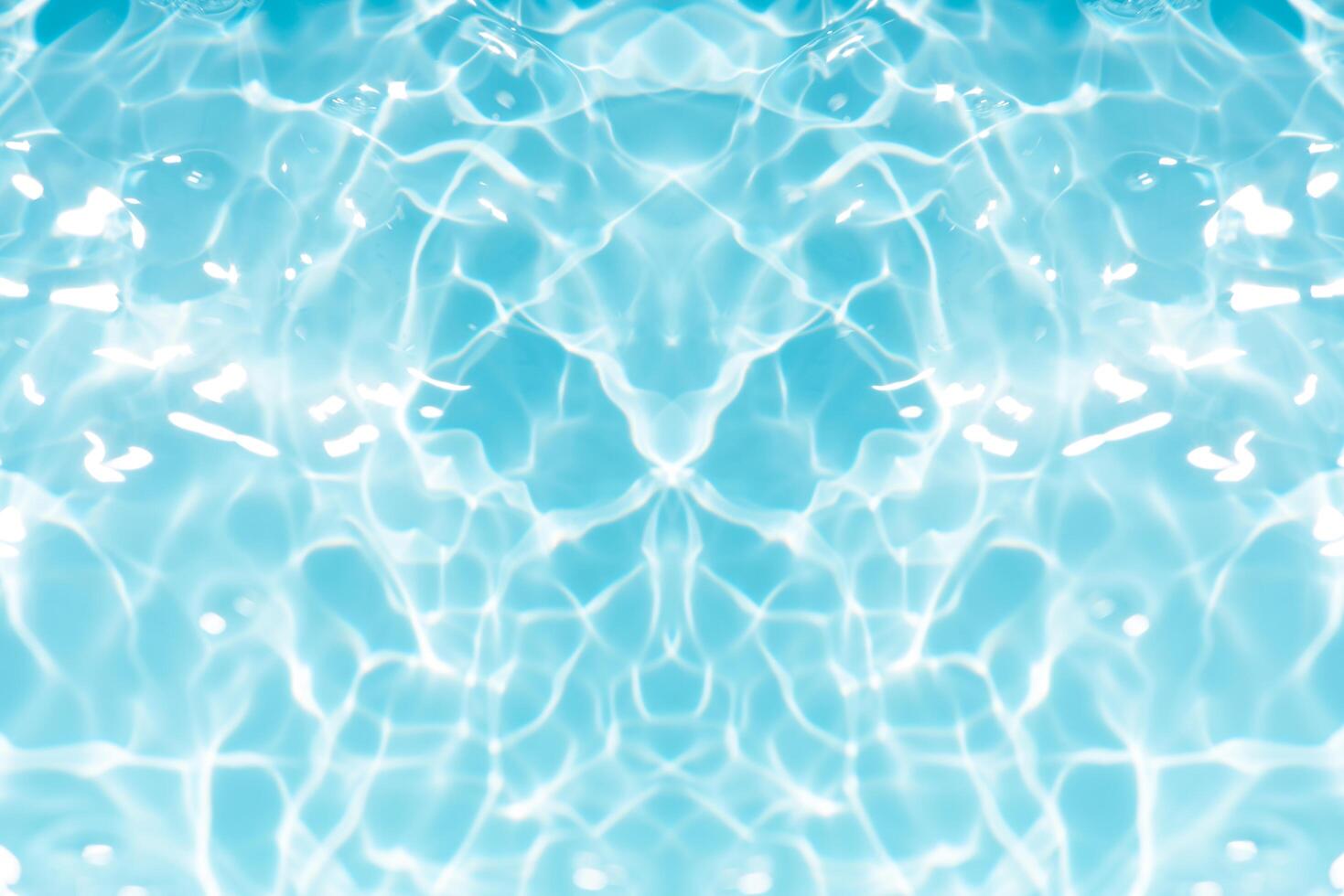 Blue water with ripples on the surface. Defocus blurred transparent blue colored clear calm water surface texture with splashes and bubbles. Water waves with shining pattern texture background. photo