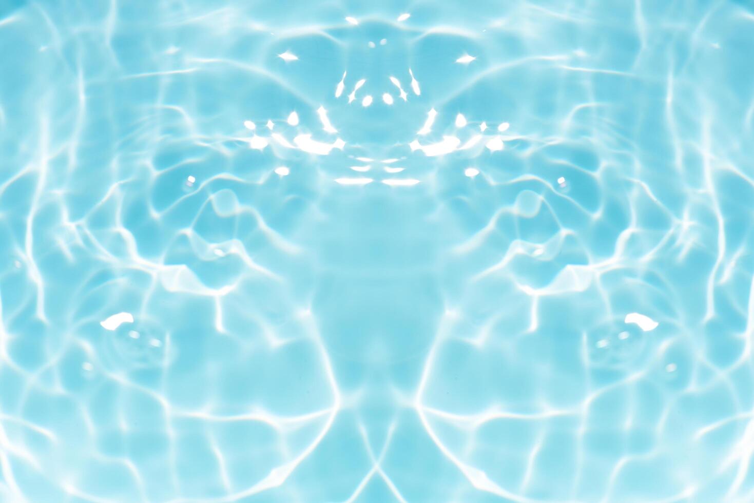 Blue water with ripples on the surface. Defocus blurred transparent blue colored clear calm water surface texture with splashes and bubbles. Water waves with shining pattern texture background. photo