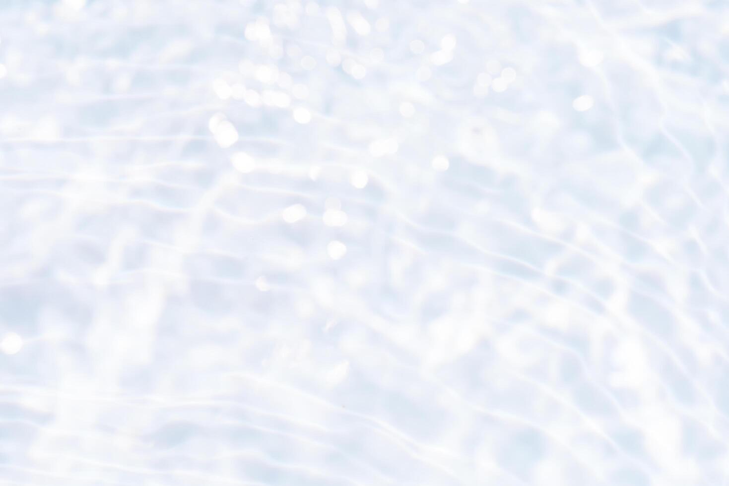 Bluewater waves on the surface ripples blurred. Defocus blurred transparent blue colored clear calm water surface texture with splash and bubbles. Water waves with shining pattern texture background. photo