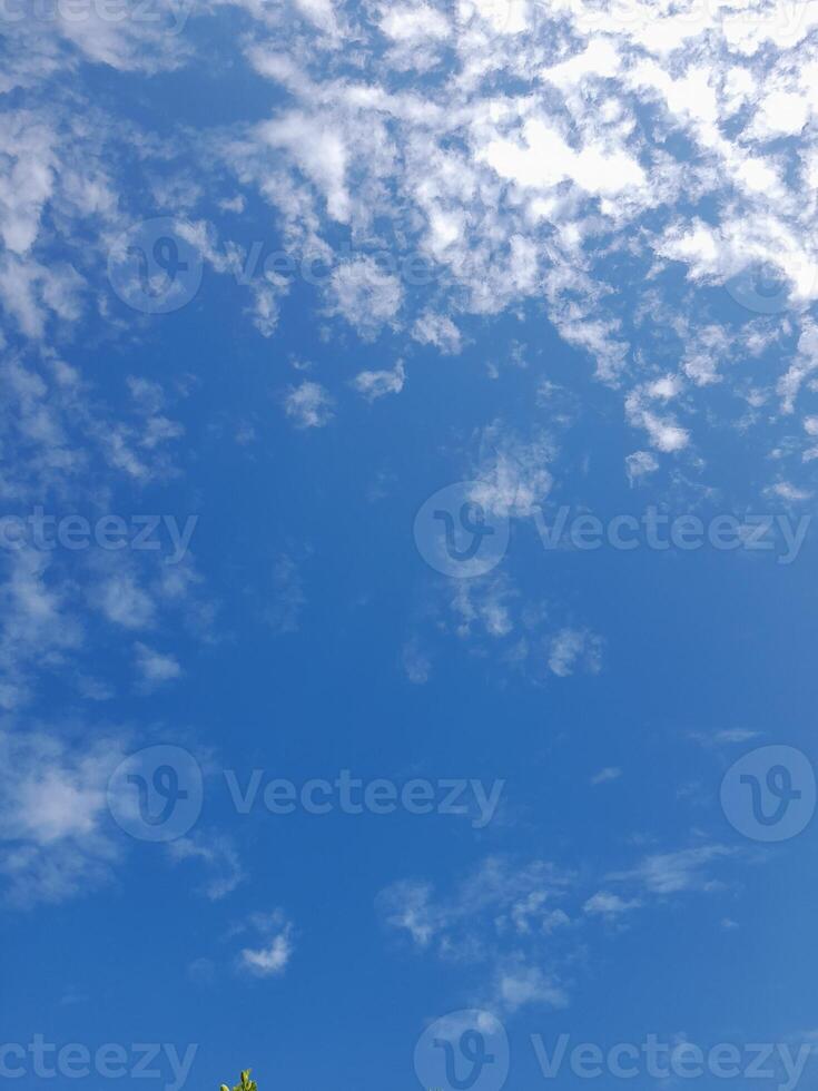 Beautiful white clouds on deep blue sky background. Large bright soft fluffy clouds are cover the entire blue sky. photo