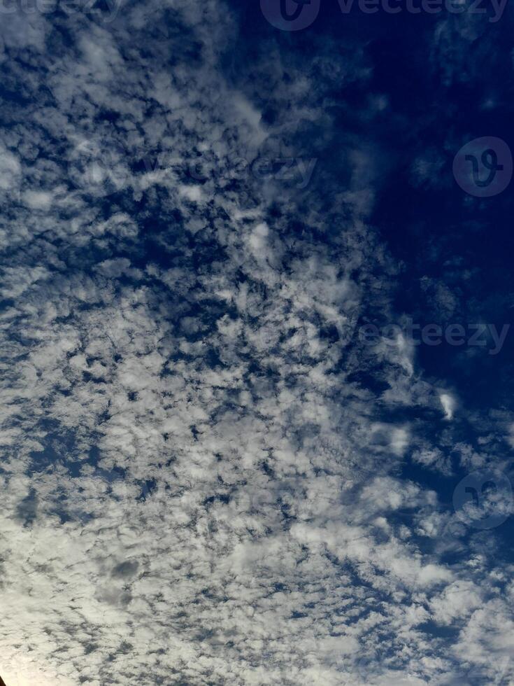 Beautiful white clouds on deep blue sky background. Large bright soft fluffy clouds are cover the entire blue sky. photo