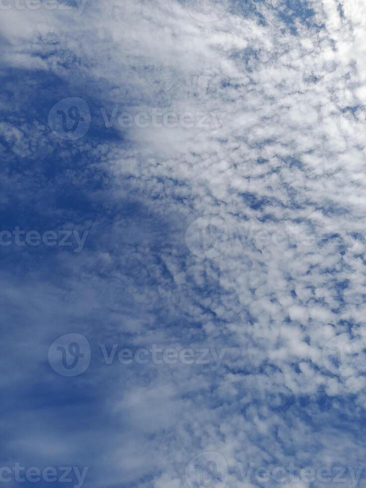 Beautiful white clouds on deep blue sky background. Large bright soft fluffy clouds are cover the entire blue sky. photo