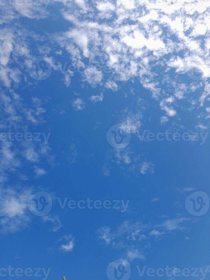 Beautiful white clouds on deep blue sky background. Large bright soft fluffy clouds are cover the entire blue sky. photo