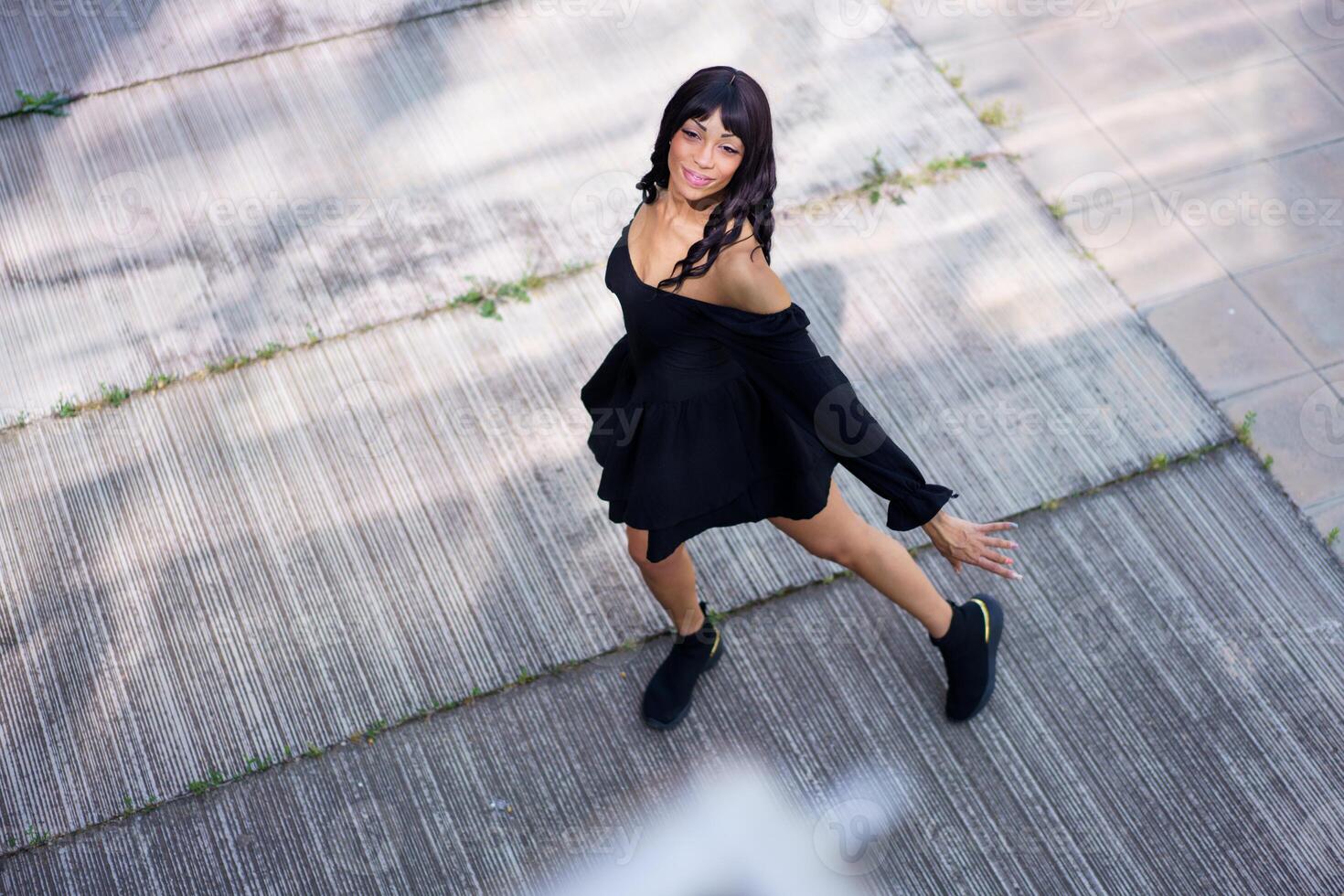 Glamorous dancer performing looking up on the street photo