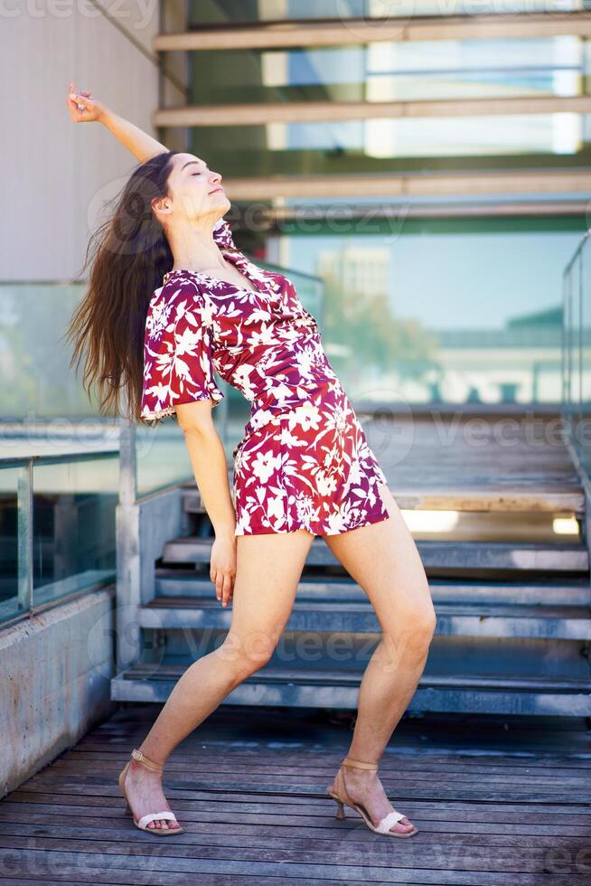 Dancer performing free style raising the arm in the street photo