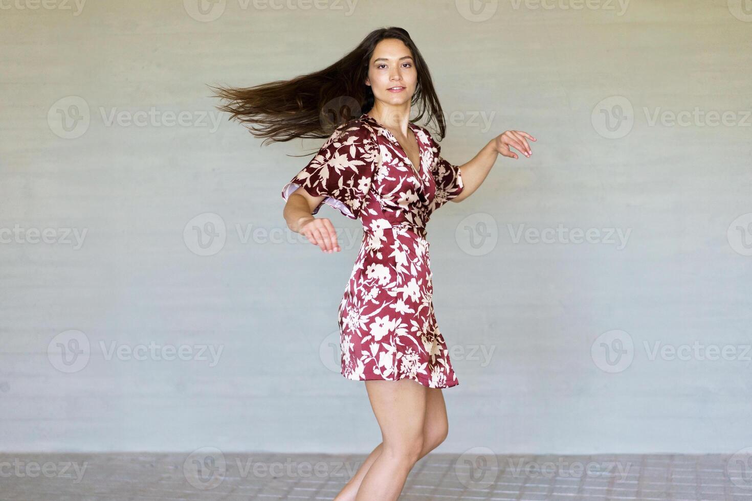 Dancer turning energetically and looking at camera in the city photo