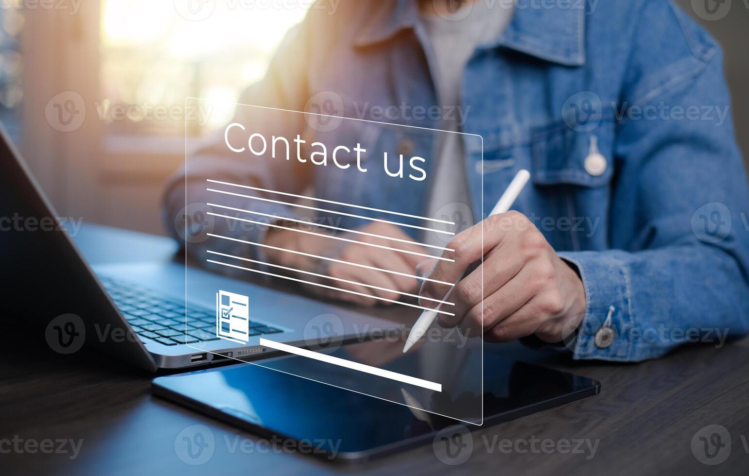 Communication and Contact us or Customer support hotline people connect. Hand using a laptop and touching on virtual screen contact icons, email and address, live chat with internet wifi. photo