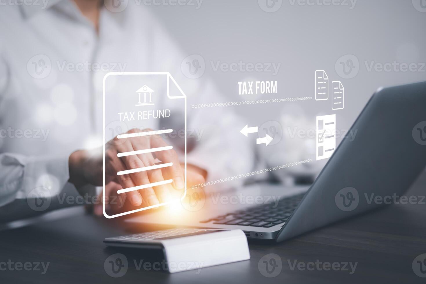 Man using a laptop with TAX REFUND and refund tax of duty taxation business, graphs and chart being demonstrated on the screen media, tablet pc and selecting tax refund, Saving tax for business photo