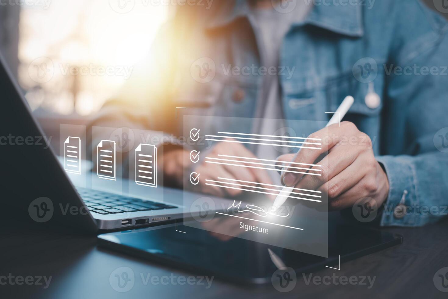 Businessman signing electronic signature, smart contract paperless office,Electronic Signing Businessman signs electronic documents on digital documents on virtual laptop screen using stylus pen photo