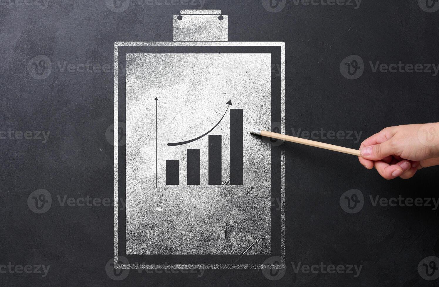 A folder holder for sheets of paper with a graph drawn with white chalk on a black chalk board photo