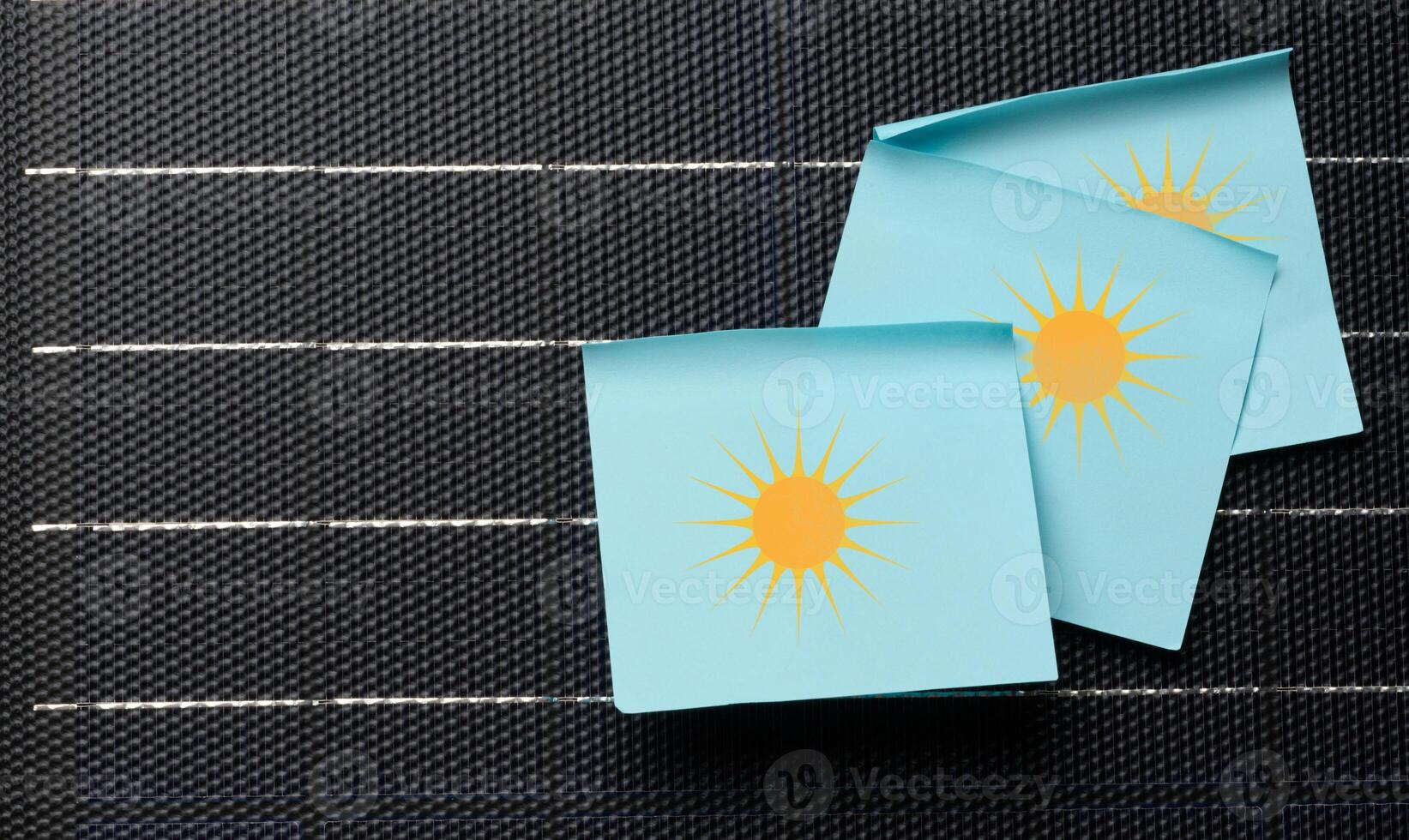 Paper stickers glued on black solar panel, renewable energy photo