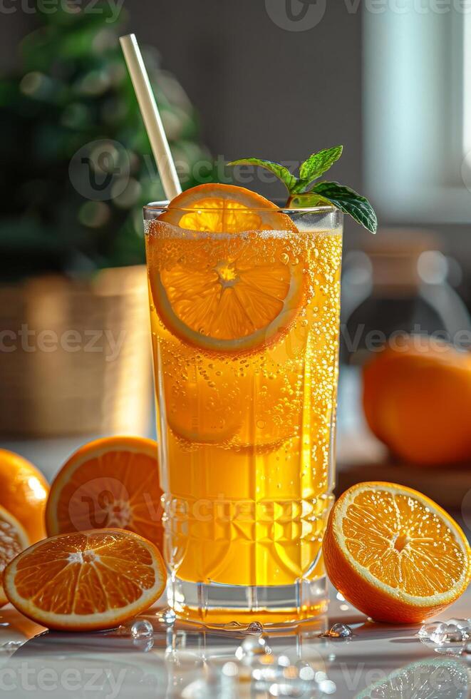 Fresh orange juice in glass and orange slices with mint and ice on table photo