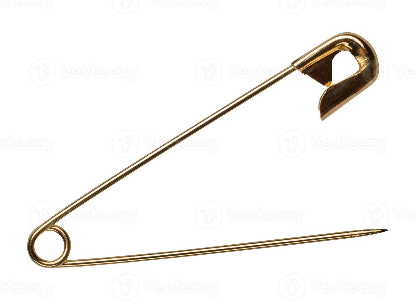 Golden metal safety pin on isolated background photo