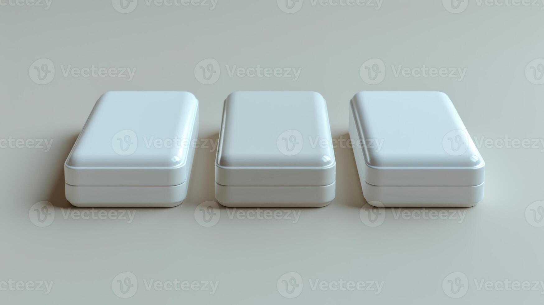 Three white rectangular plastic containers arranged in a row on a light gray surface, minimalistic and clean design. photo