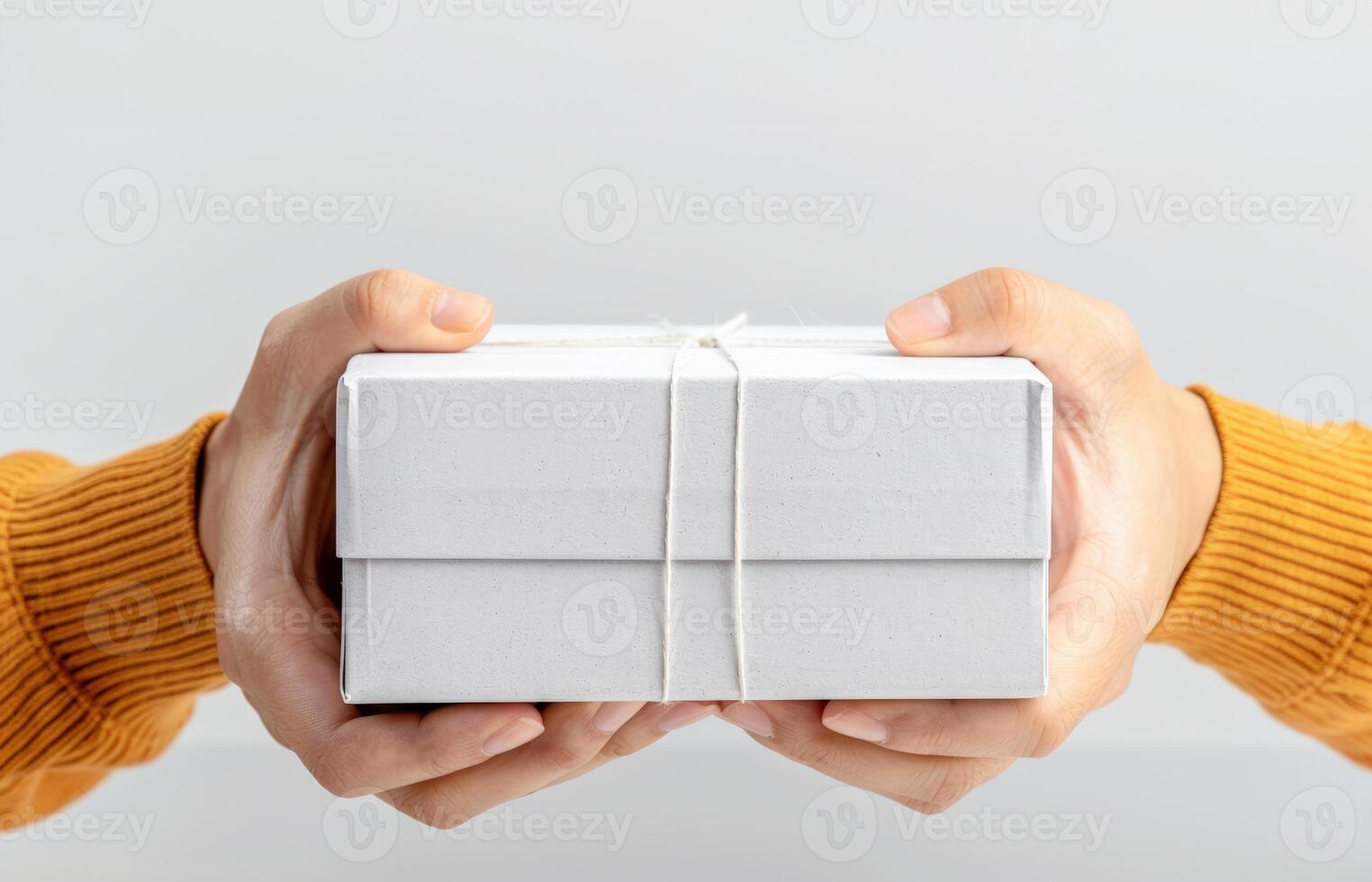 a person holding a white gift box photo