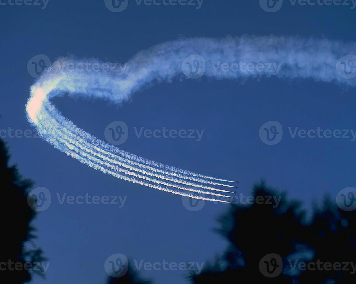 Airshow of military jet fighters. Group of military airplanes performs maneuvers with a smoke trace. Aviation background photo