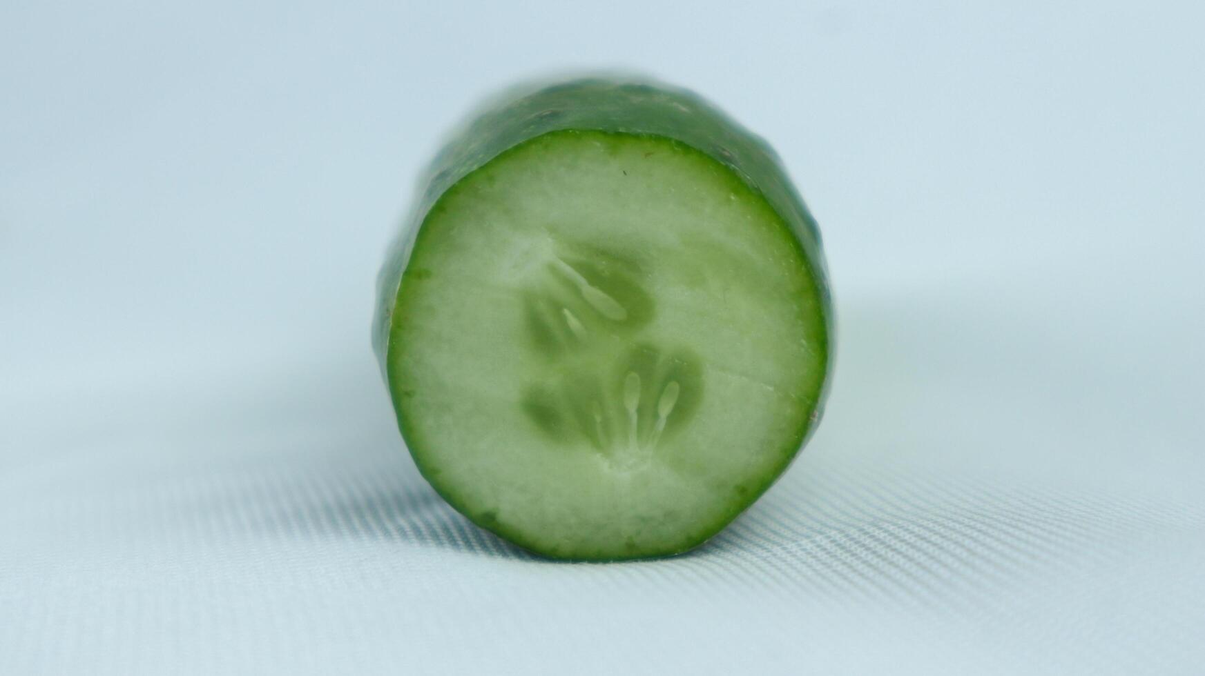 single sliced cucumber isolated on white background photo