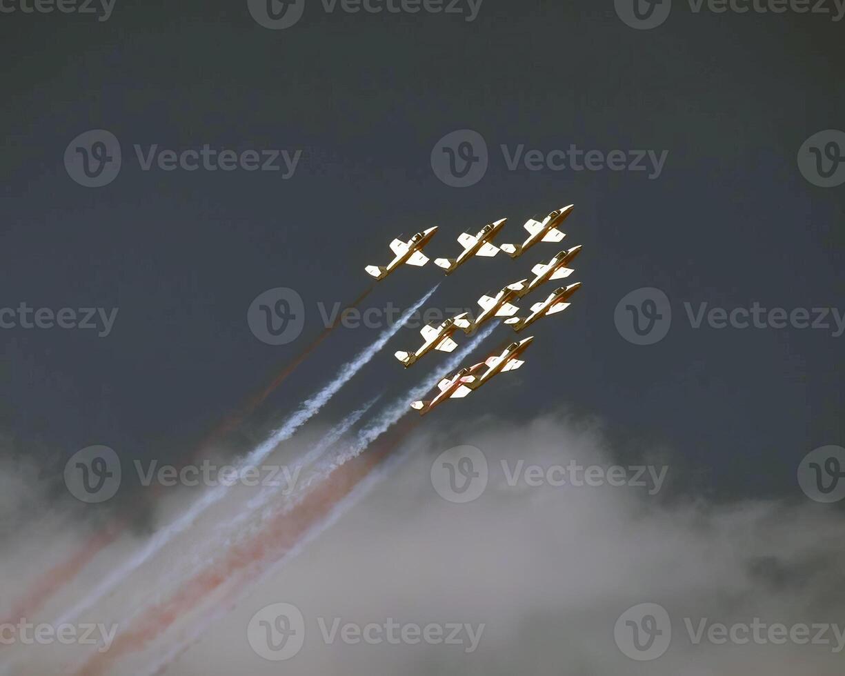 Airshow of military jet fighters. Group of military airplanes performs maneuvers with a smoke trace. Aviation background photo