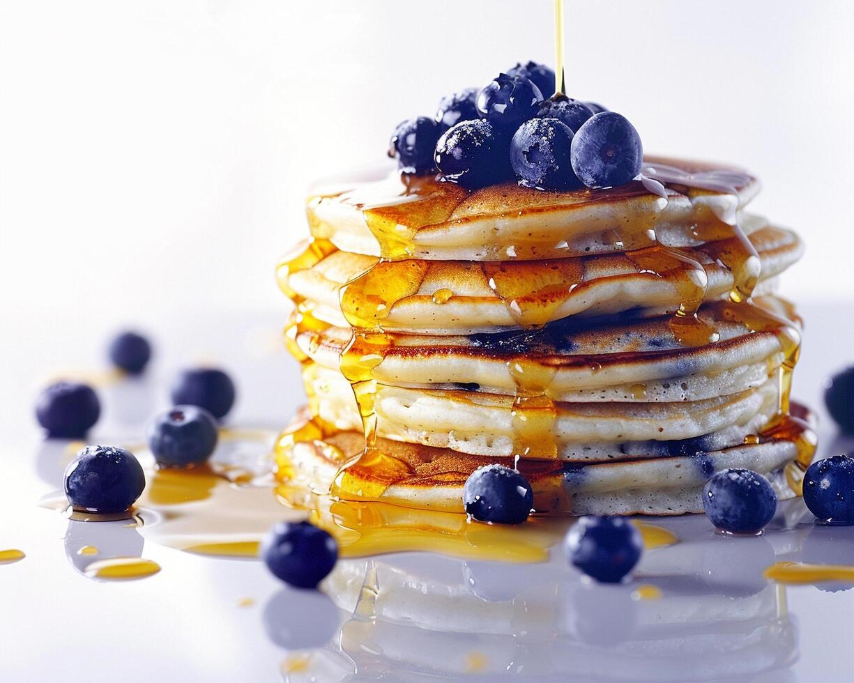 a stack of pancakes with syrup and blueberries photo