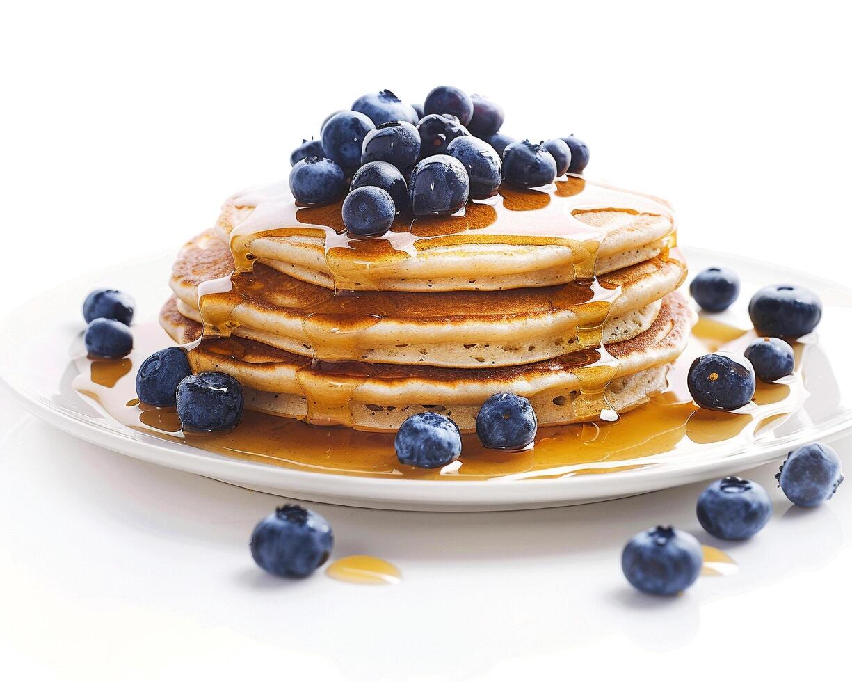 a stack of pancakes with syrup and blueberries photo
