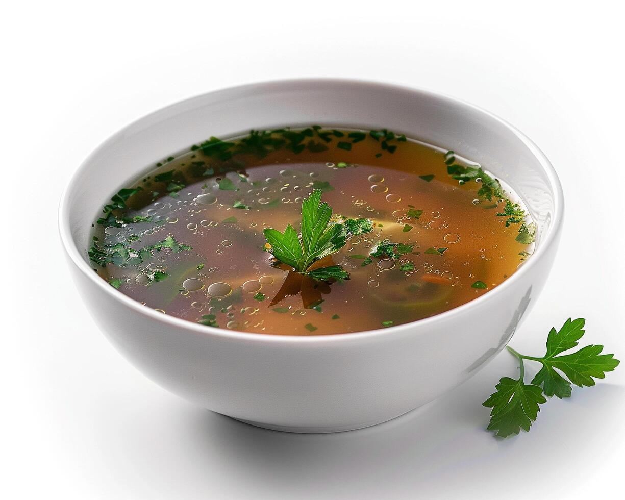 a bowl of soup with herbs and parsley photo