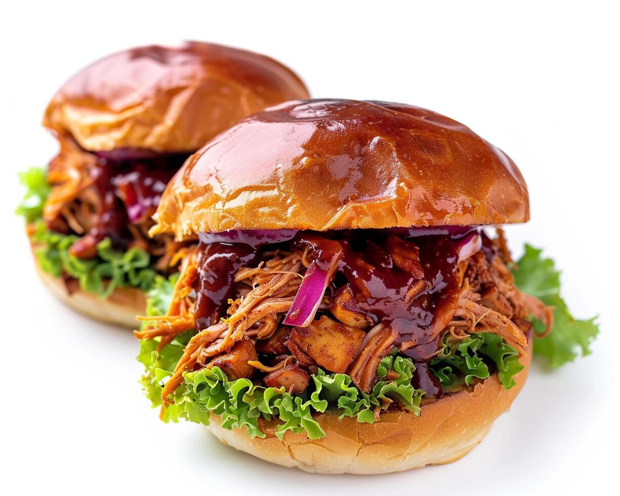 two pulled pork sandwiches with bbq sauce on a white background photo