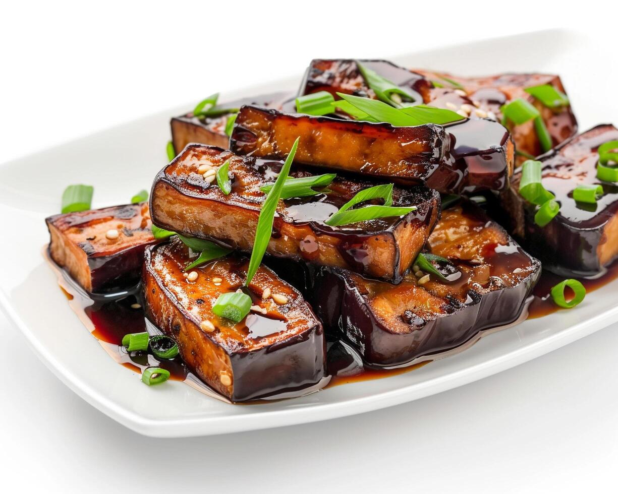 a plate of tofu with sauce and green onions photo