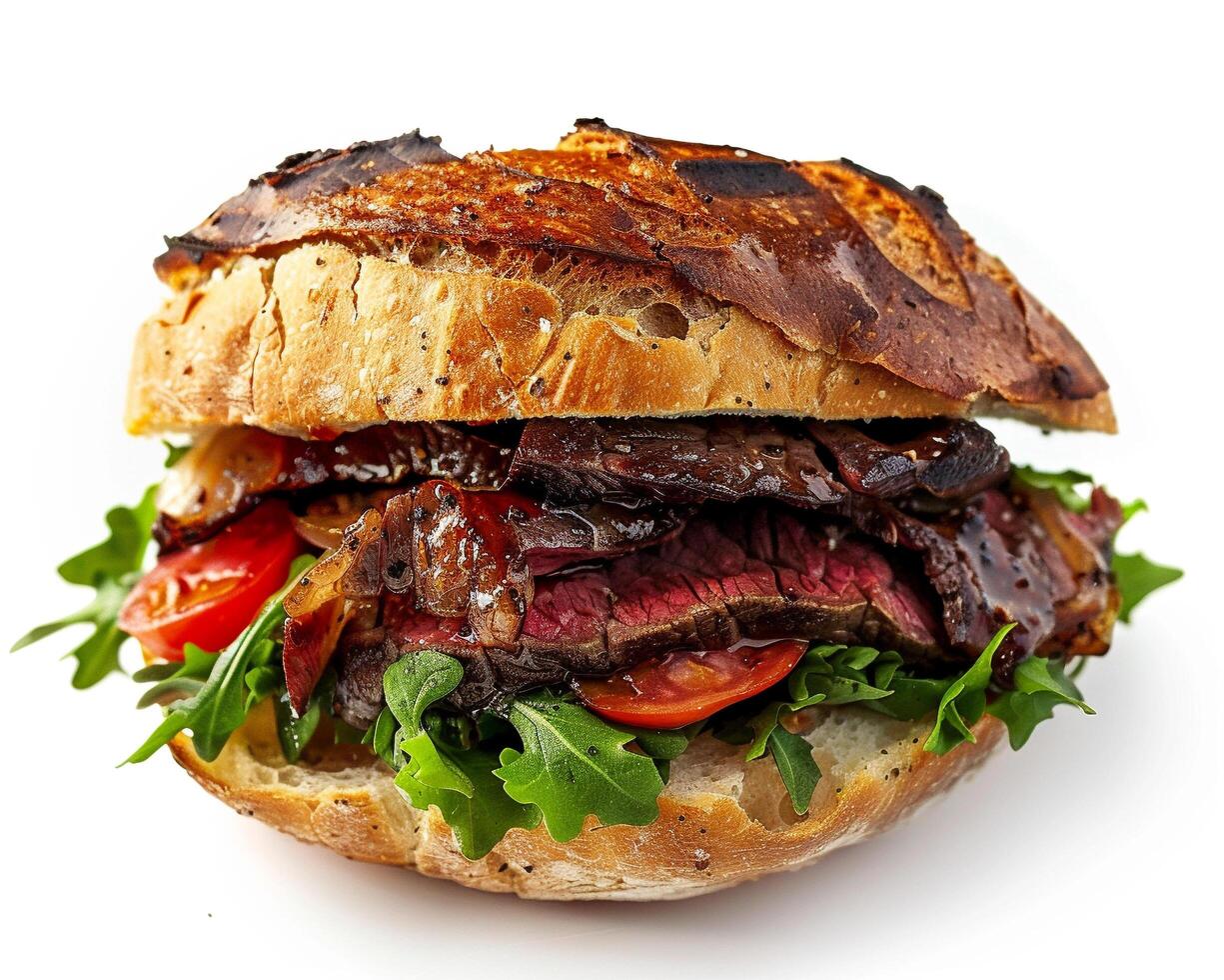 a beef sandwich with lettuce, tomatoes and arugula photo