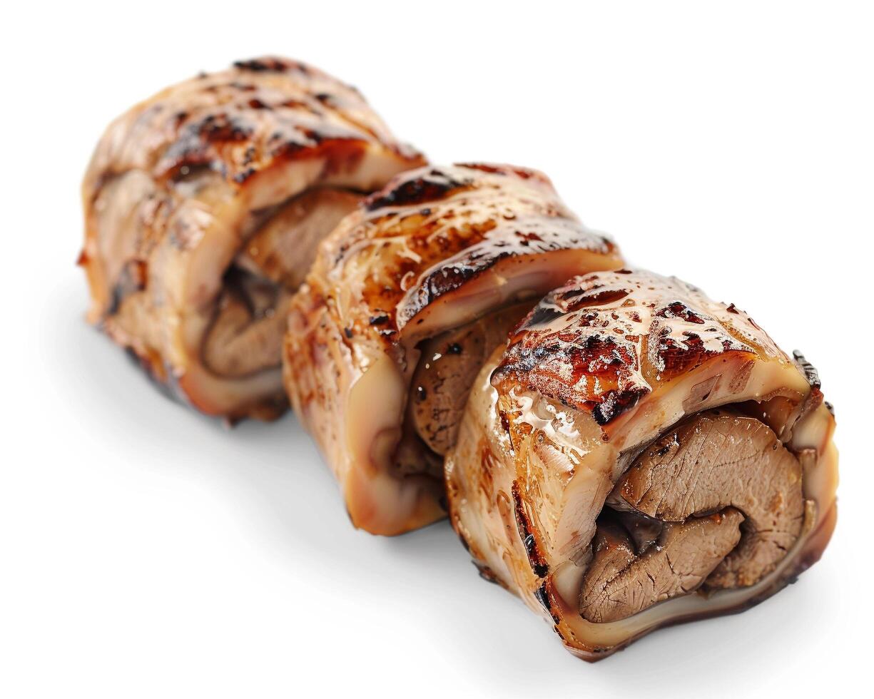 three pieces of meat wrapped in bacon on a white background photo