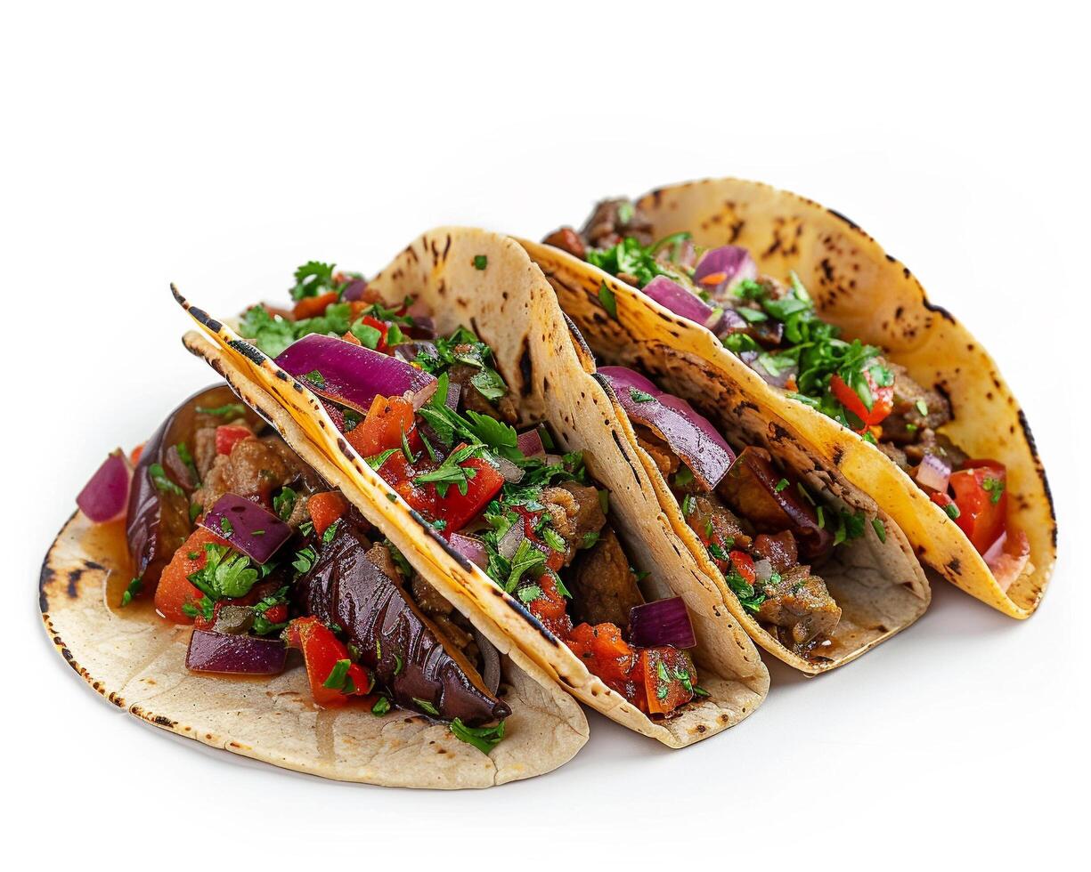 three tacos with vegetables on a white surface photo